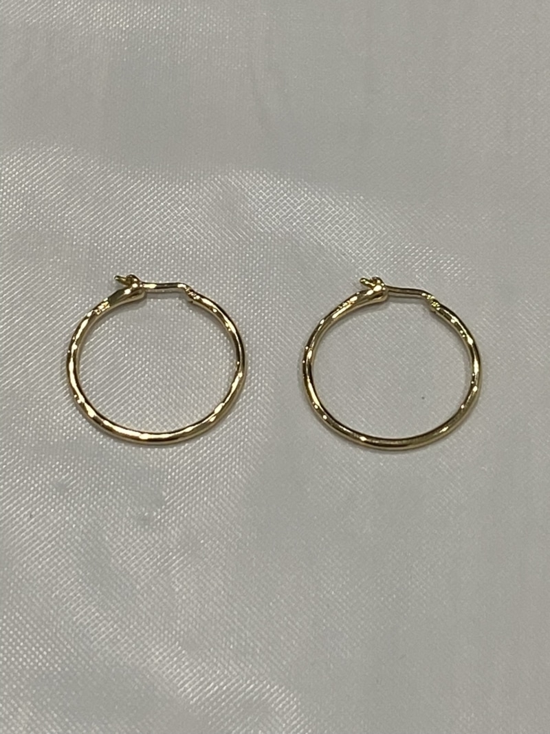 closeup of the gold medium-size siren hoop earrings by Washed Ashore