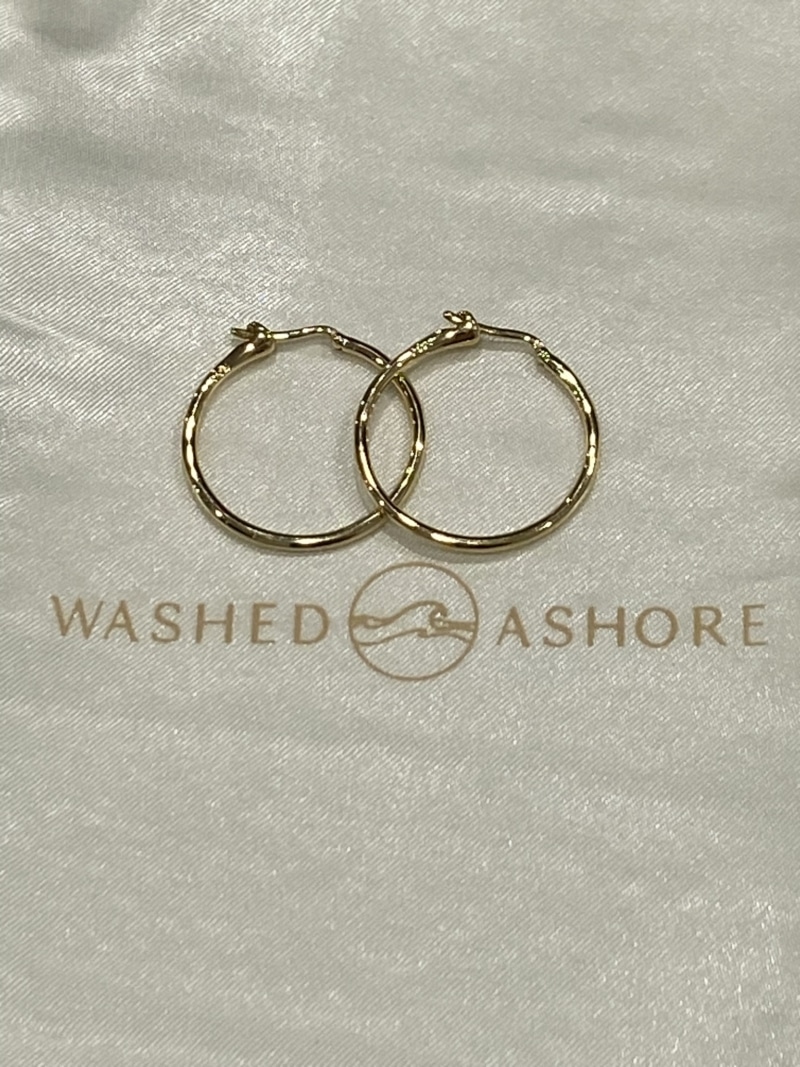 closeup of the gold medium-size siren hoop earrings by Washed Ashore